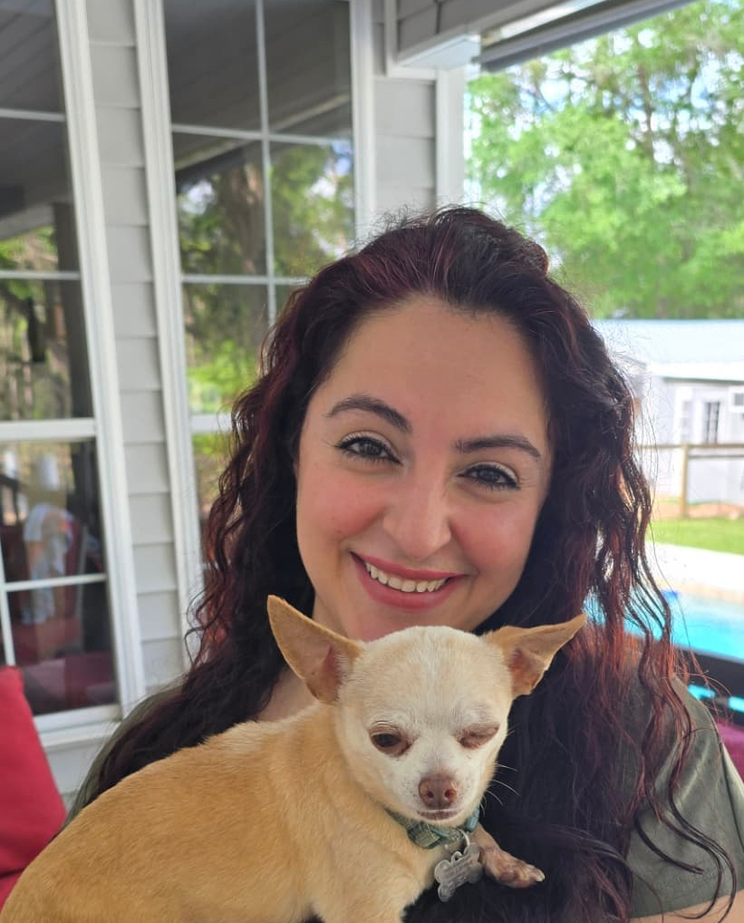 Dr. Sally Nazari holding her dog Cisco on the porch at Full Circle Retreats