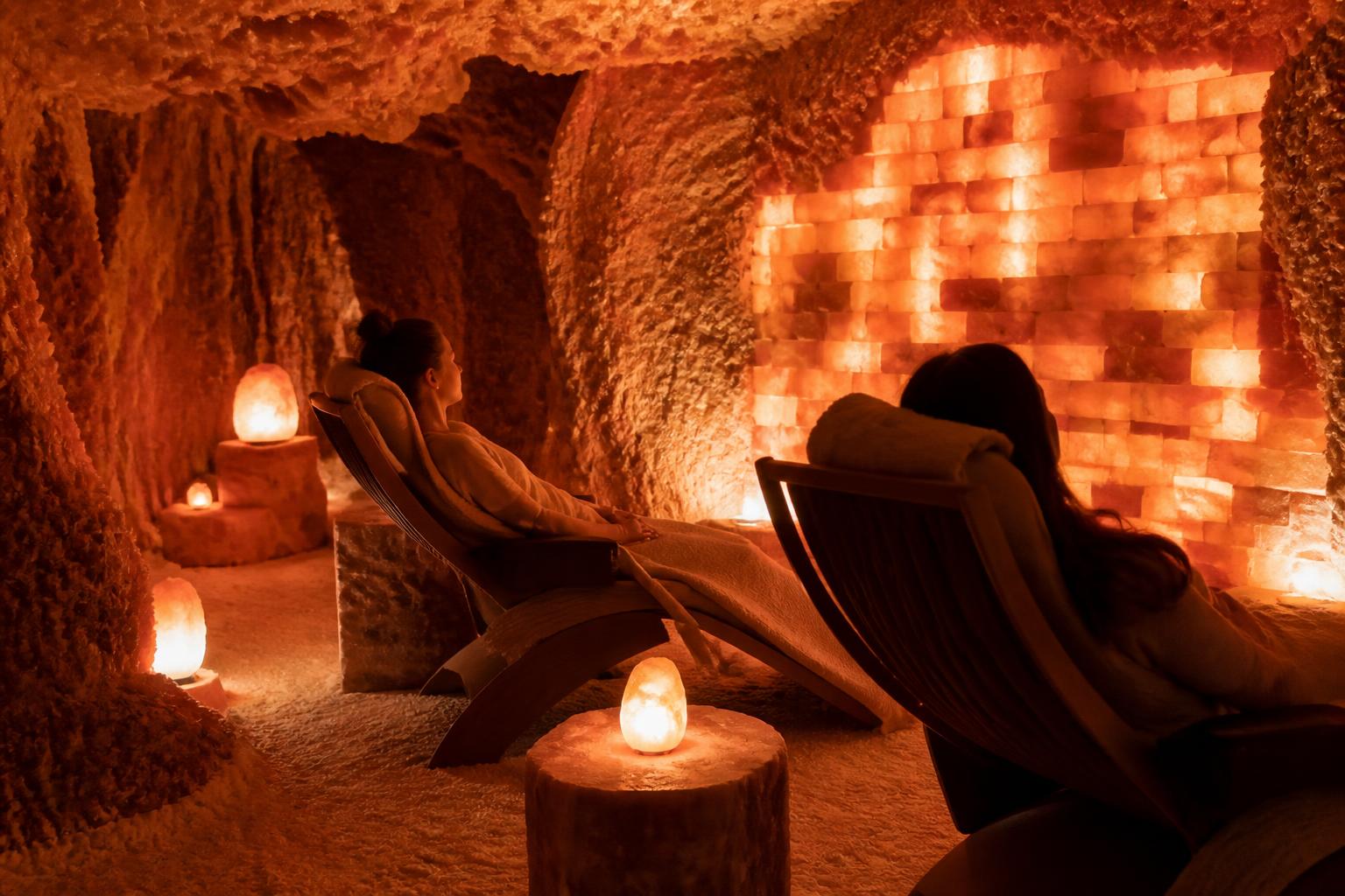Women resting inside a glowing Himalayan salt cave